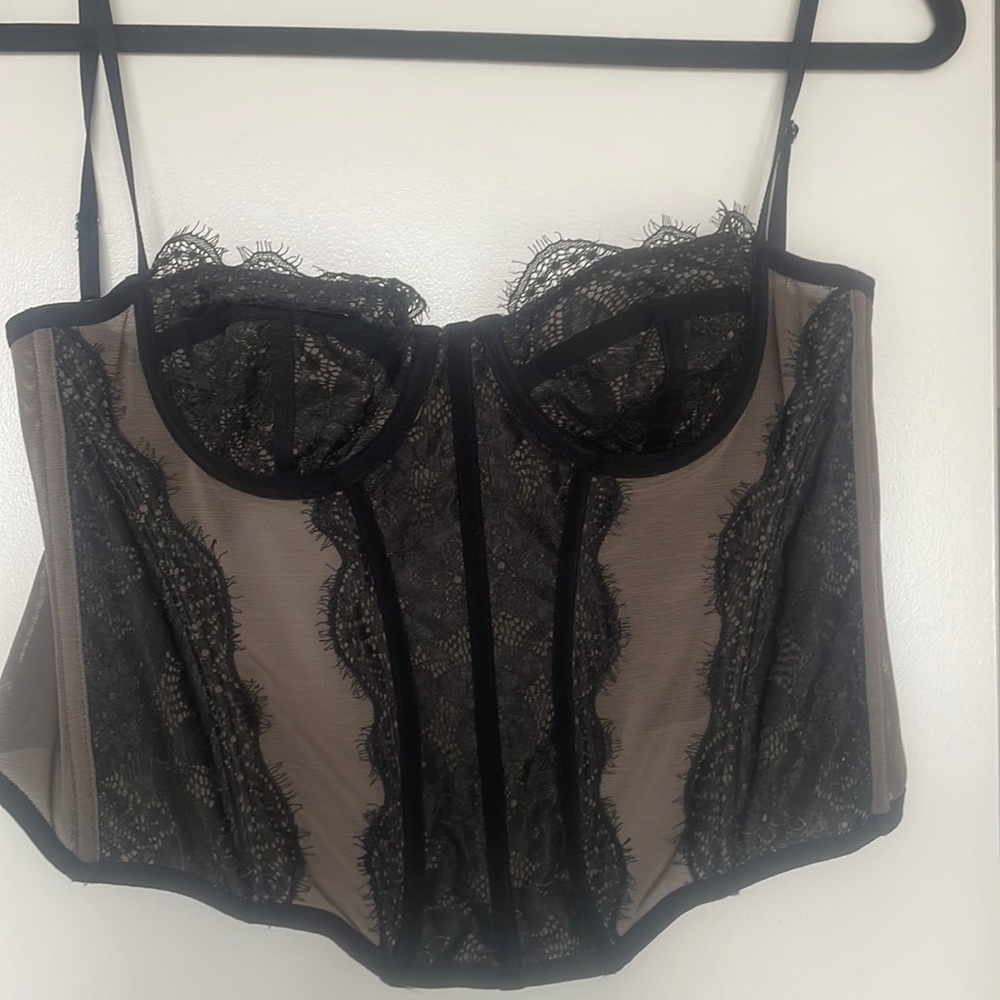 Brown and black corset top with lace on it